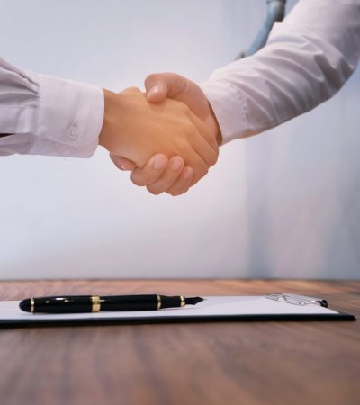 Real estate agent handshake. Business partnership meeting concept.